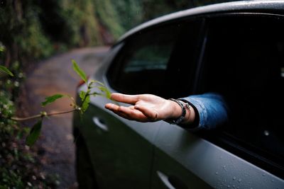 Cropped hand of man holding car