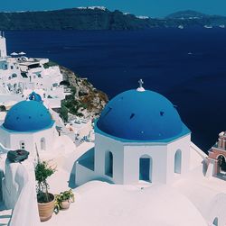 Panoramic view of sea and buildings against blue sky