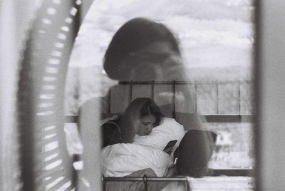 Portrait of woman sitting by window