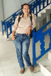 Portrait of smiling mature woman standing by railing