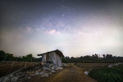 House on field against sky at night