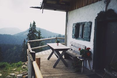 Empty chairs and tables against building