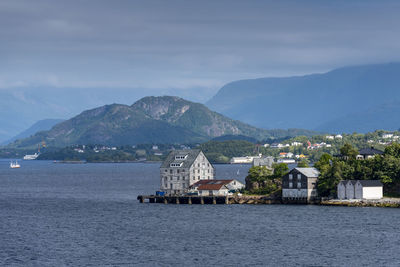 Scenic view of sea by buildings against sky