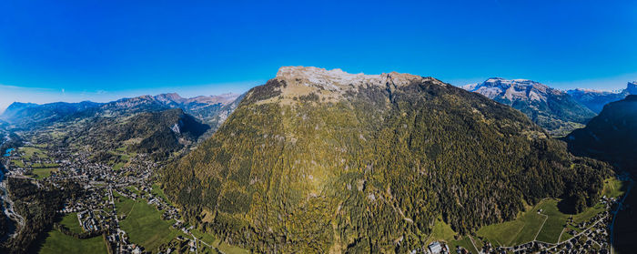 Scenic view of mountains against blue sky