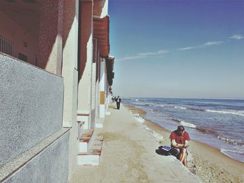 People on beach against sky