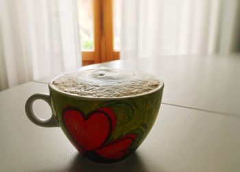 Close-up of coffee cup on table