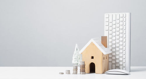 Close-up of small house on table against white background