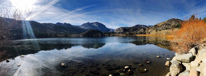 Scenic view of lake and mountains against sky