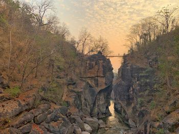Rock formation on land against sky during sunset