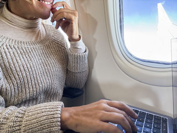 Midsection of woman using laptop