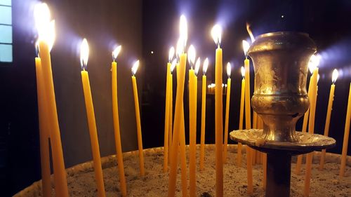 Close-up of burning candles at orthodox church