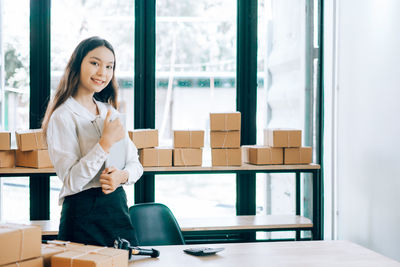 Young woman smiling while standing in box