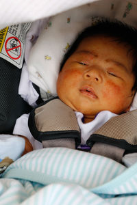 Cute baby boy sleeping on bed