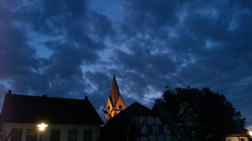 Low angle view of church against cloudy sky