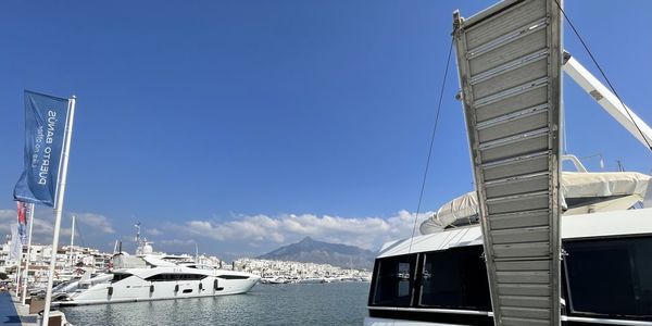 Sailboats in sea against clear sky