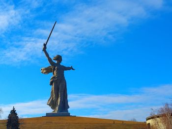 Low angle view of statue against blue sky