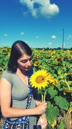 Young woman holding sunflower