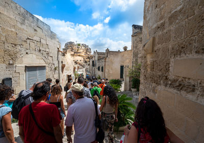 Rear view of people walking on street