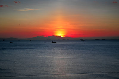 Scenic view of sea against orange sky