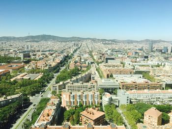 High angle shot of cityscape against blue sky