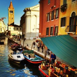 Boats in canal with buildings in background