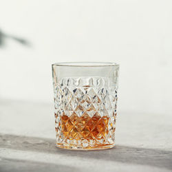 Close-up of drink in glass against white background