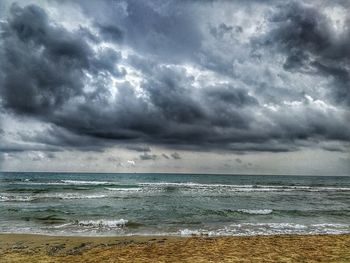 Scenic view of sea against storm clouds