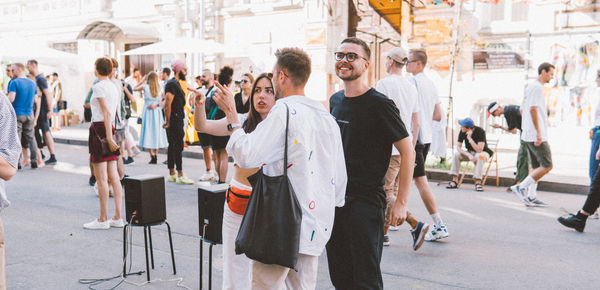 Group of people walking on street in city