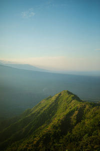 Scenic view of sea and mountains against sky