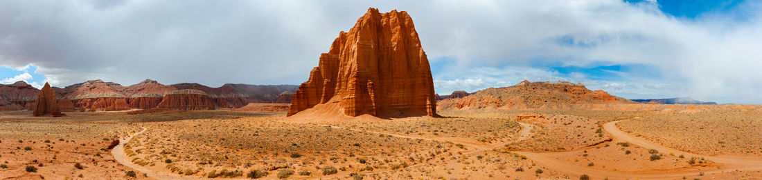 Panoramic view of rock formations on landscape against sky