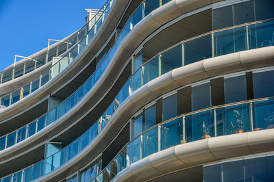 Low angle view of modern building against clear blue sky