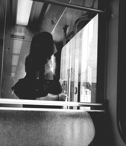 Woman sitting by window