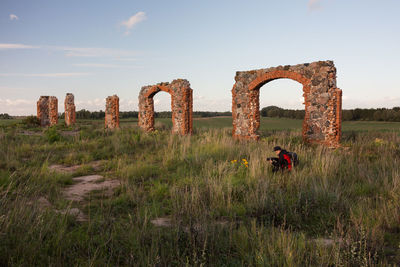 Old ruin on field against sky