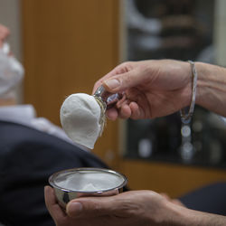 Cropped hand of man holding coffee