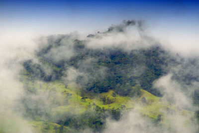 Scenic view of foggy weather against sky