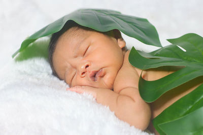 Portrait of cute baby sleeping on bed