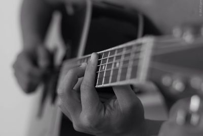Close-up of cropped hand holding guitar