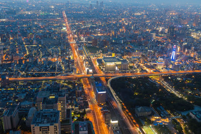 High angle view of illuminated buildings in city