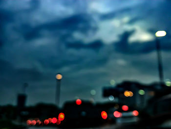 Low angle view of illuminated city against sky at dusk