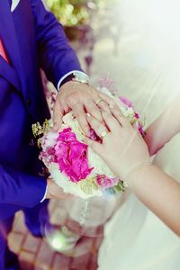 Close-up of couple holding hands