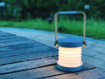 Close-up of electric lamp on boardwalk