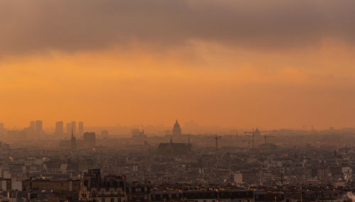 High angle view of buildings in city during sunset