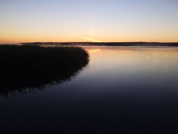 Scenic view of calm lake at sunset