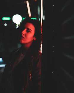 Portrait of woman in dark room