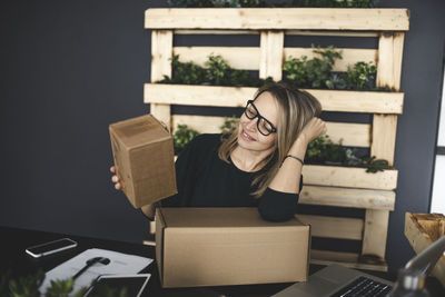 Young woman sitting in box