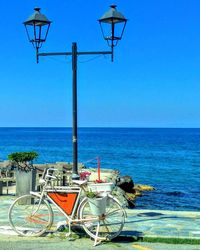 Deck chairs on beach against clear blue sky