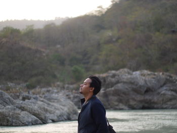 Side view of man standing outdoors