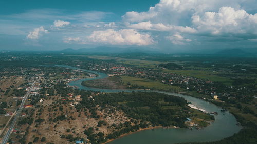 High angle view of river and cityscape against sky