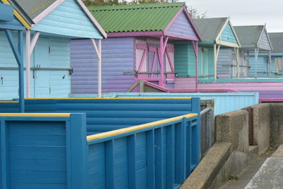 Multi colored houses by building in city