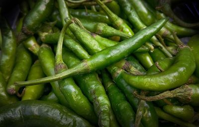 Close-up of green chili peppers in market